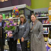Julie, holding the flowers, with Paul Chudley, the regional operational manager (left) and other colleagues at the Co-op store