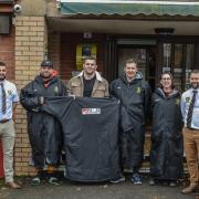 N&G Groundworks representatives present the new sub suits to the club.