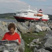 Pictured is Margaret in the Lofoten Islands beside the ship, the MS Nordlys, near the North Cape, north of the Russian border