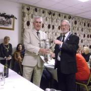 Club Captain Dave Crouch receiving the Des Jones Cup for the over 60s single from Men’s County President Paul Davies.