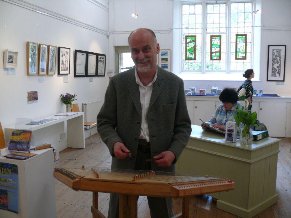 DAMIAN Clarke entertains visitors to Ilminster Arts Centre on Saturday, where his art exhibition is on show, by playing the dulcimer.