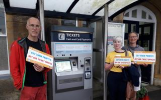 Crewkerne residents gathered outside the train station with  “Cut their profits, not our ticket offices” signs. Picture: Supplied by Ben Hartshorn
