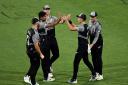 Ish Sodhi celebrates with New Zealand teammates after a wicket.
