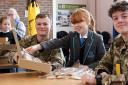 Students and soldiers pack Christmas boxes