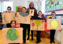 Rt Revd Ruth Worsley, Bishop of Taunton visits Winsham Primary School ; pictured with pupils showing their work inspired by the school's return to C of E Status.