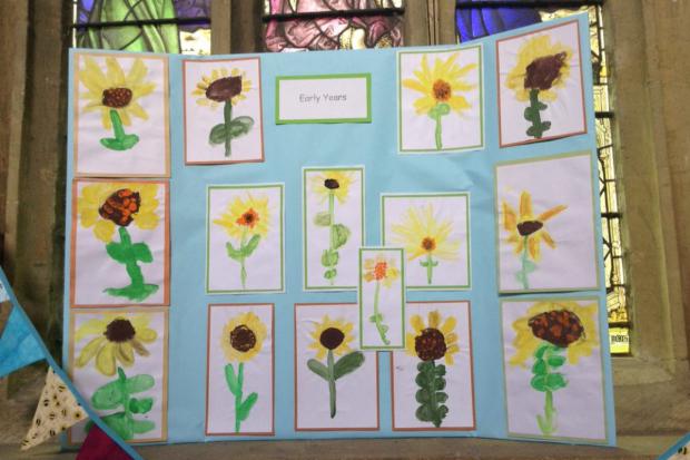 Chard & Ilminster News: Early years pupils' sunflower artwork on display at the Minster. Picture: Greenfylde First School