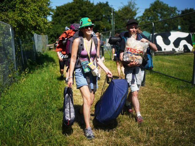 Chard & Ilminster News: People arrive on the first day of the Glastonbury Festival at Worthy Farm in Somerset (PA/PA Wire. Photo by Yui Mok