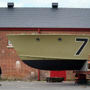 ICONIC: Nick Hewitt, from the National Museum of the Royal Navy, looks up at the historic Second World War Motor Torpedo Boat MTB 71