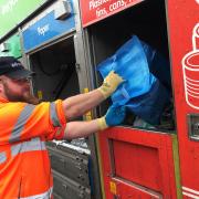 Recycling being loaded into the new Suez lorries by a Somerset Waste Partnership employee.