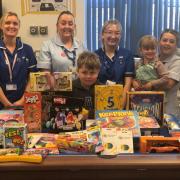 Toby and members of staff at Musgrove Park Hospital with the toys and games donated by the Keates family. Picture: Sam Keates