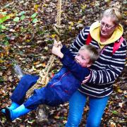 A child has fun on Magdalen Farm's rope swing during ASCape's family activity afternoon.