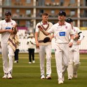 Somerset bowlers leaving the pitch at Taunton.